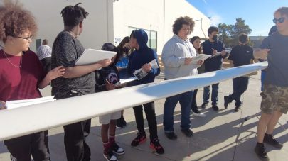 iLEAD Lancaster learners stand near a glider wing.