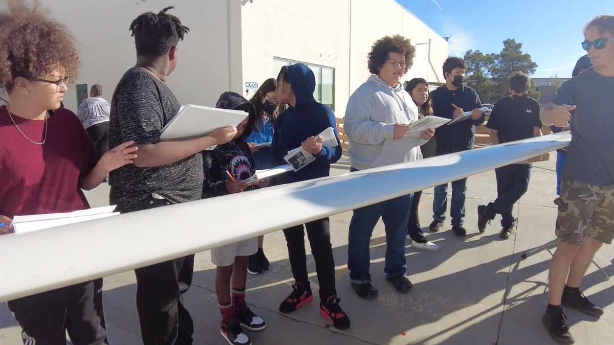iLEAD Lancaster learners stand near a glider wing.