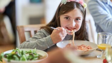 girl eating pasta